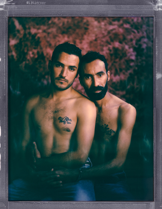 Tunisia, Sousse. 03 December, 2016. A posed portrait of 37 year old, gay man Walid (right) (+216 97746228, walidnasrkhlifi@gmail.com, FB: Walid Nasr) and 26 year old, gay man Abdesattar (left) (+216 22560992, abdessattarwasli@gmail.com). They have been together for five years, but because of hostile attitudes towards same sex relationships in the region and laws that make some consensual same sex acts a crime, they have kept their relationship hidden. ÒWe moved from place to place, lied to families and friends. We had to pretend and to be someone else. We love each other and we will never give up on each other, whatever happens.Ó Photo Robin Hammond /NOOR for Witness Change.  The Tunisian Revolution, also known as the Jasmine Revolution, was an intensive campaign of civil resistance, including a series of street demonstrations taking place in Tunisia, and led to the ousting of longtime president Zine El Abidine Ben Ali in January 2011. It eventually led to a thorough democratization of the country and to free and democratic elections. Tunisian LGBTQI+ community hoped that the revolution would usher in a more open society, and an end to homophobia and transphobia. This has not come to pass. The laws that target LGBTQI+ people remain, most notably article 230 which makes same-sex acts illegal, punishable by up the 3 years in prison. Transgender people are targeted under public decency laws. The general public is no more accepting of LGBTQI+ people than they were before the revolution. Despite the legal and societal discrimination, LGBTQI+ activists are dedicated to campaigning more openly.